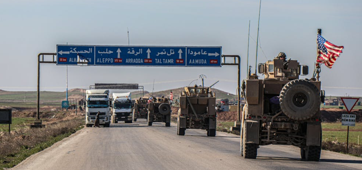 Syrian road with military convoy and directional signs